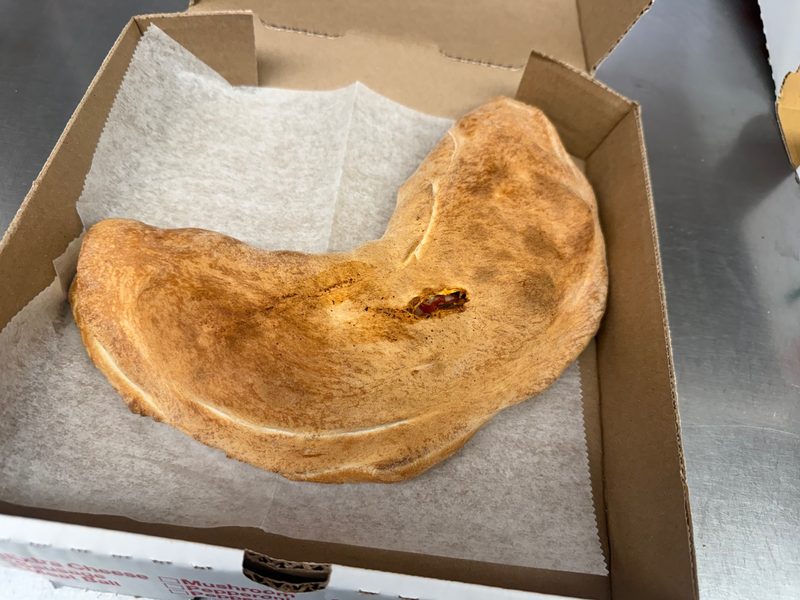 Golden baked stromboli on a metal tray